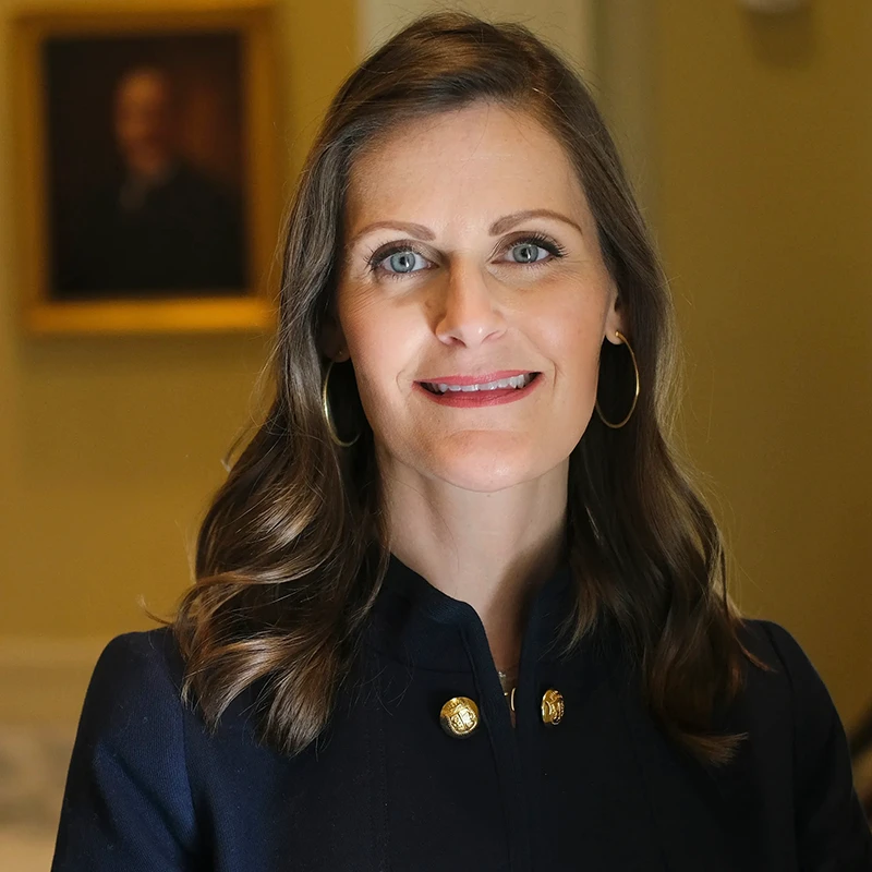 portrait of Nellie Sanders wearing a dark blue shirt.